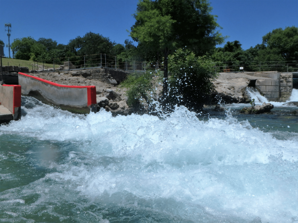 tube chute on the comal river, where is laura traveling, swimming hole near austin