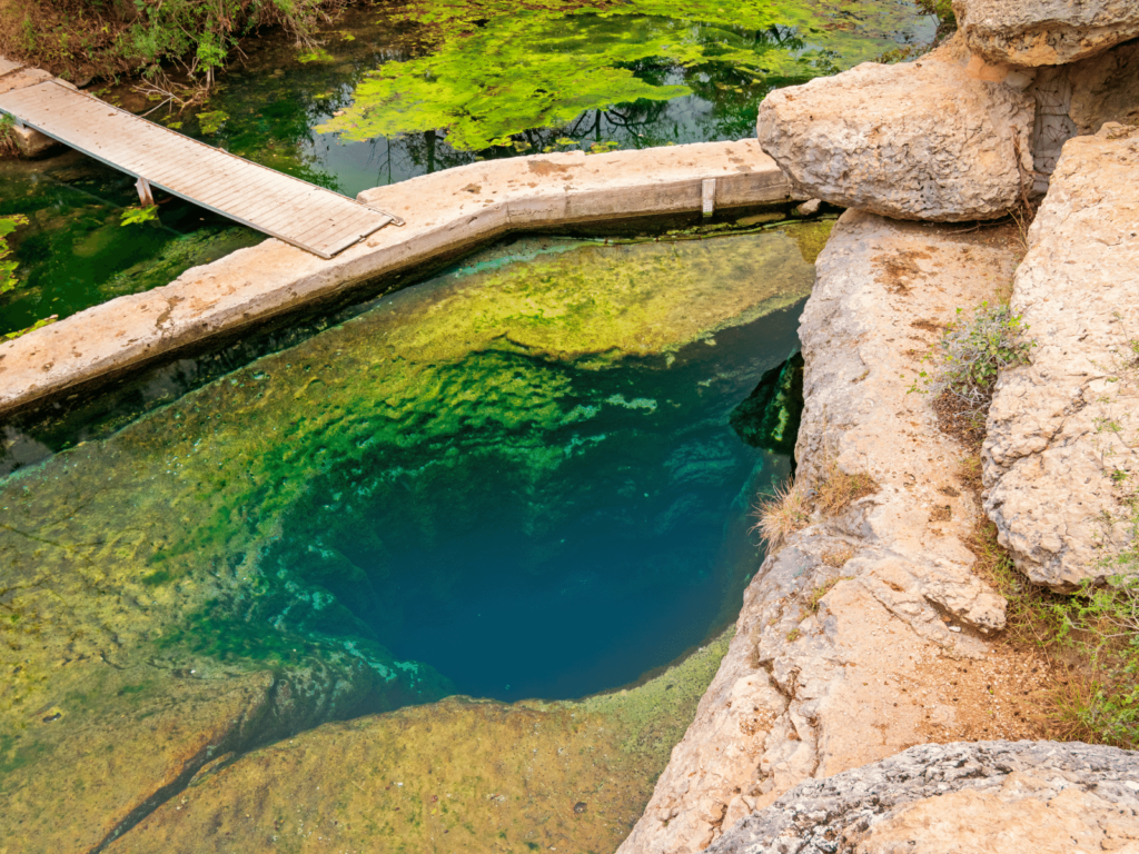 jacob's well from above, where is laura traveling, swimming hole near austin
