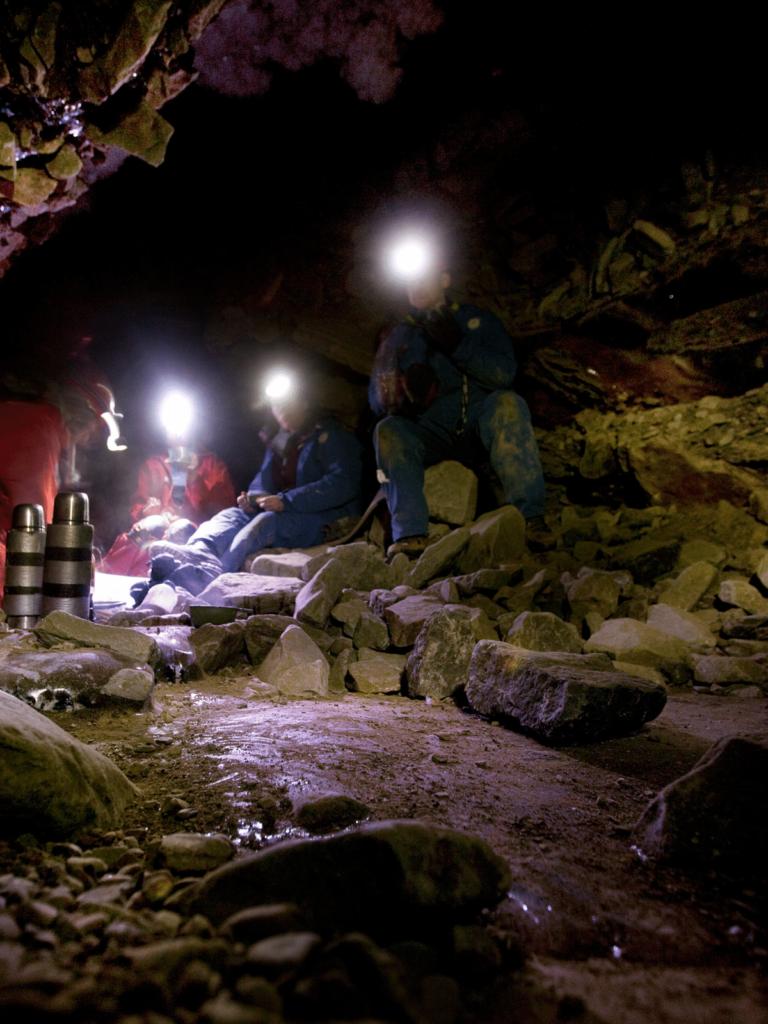 Headlamps in the cave, where is laura traveling