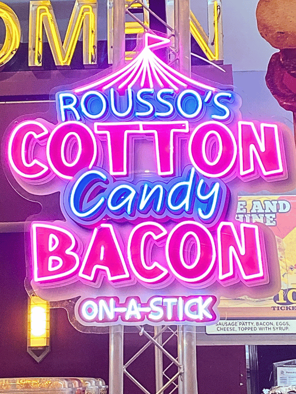 neon sign of cotton candy bacon on a stick